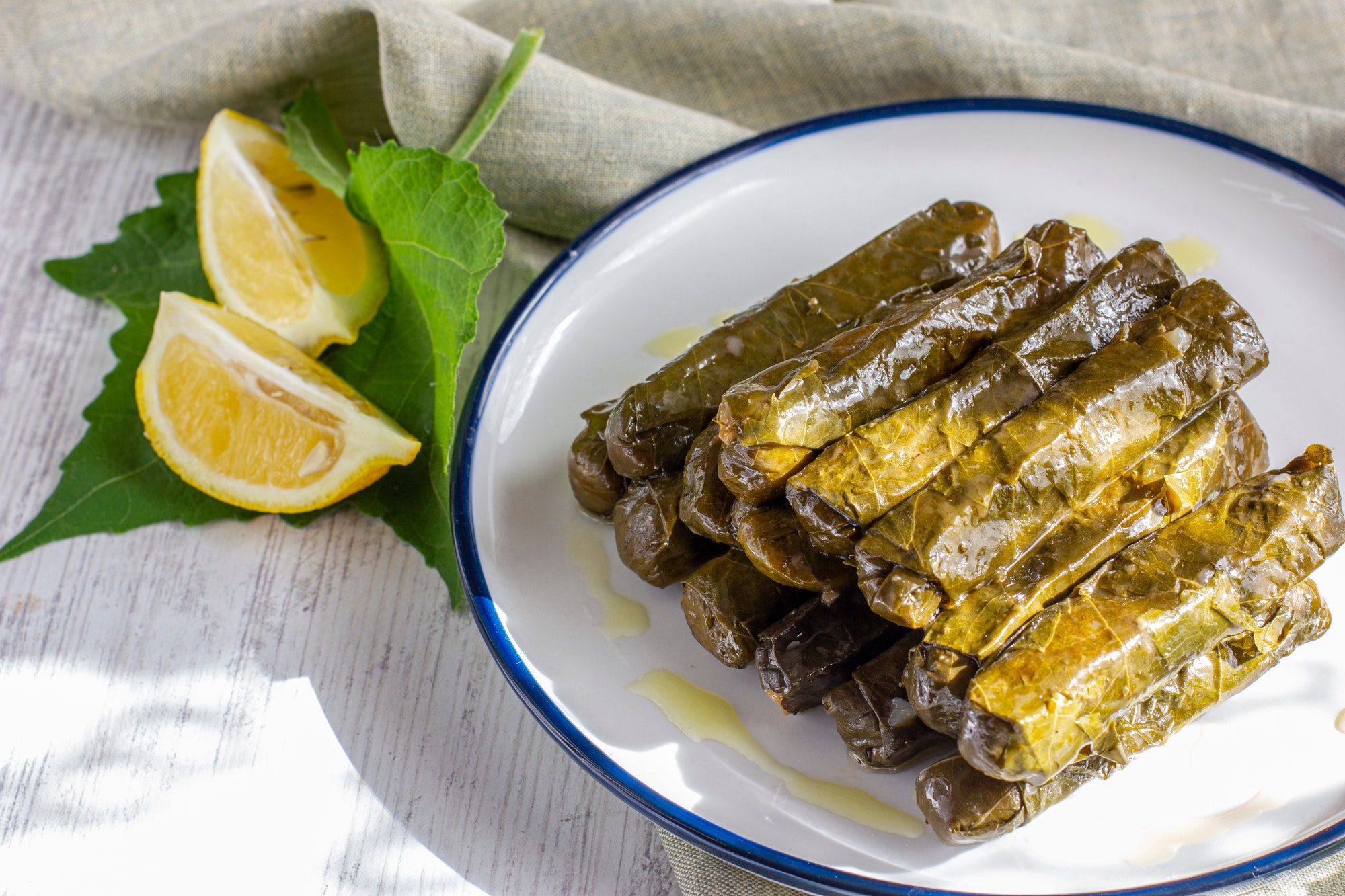 Traditional turkish meal - Yaprak sarma. Grape leaves stuffed with rice and spices. Served with oliv